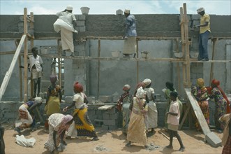 SOMALIA, Work, Settled nomads building houses.