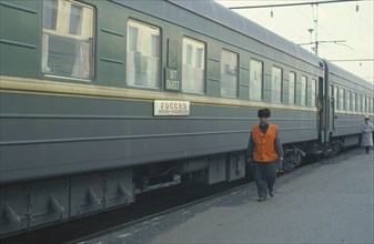 RUSSIA, Transport, Trans Siberian train and guard at platform of station.