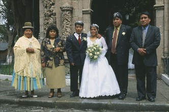 BOLIVIA, La Paz, "Wedding in El Monticulo. Bride, Groom and guests standing outside."