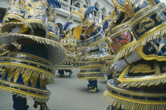 BOLIVIA, Oruro, Dancers in costume in carnival procession.