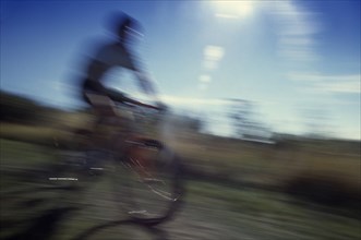 20069982 SPORT Cycling Mountain Biking Cyclist on mountain bike in blur of movement.