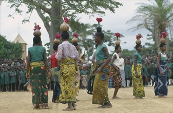 CONGO, Kimpese, Dancers at festival carrying gourds and bottles filled with flowers on their heads