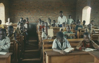 CONGO, Education, Azande children sitting at wooden desks in school classroom.
