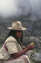 COLOMBIA, Santa Marta, Sierra Nevada , "Ica Indian taking coca, gourd in left hand has calcium