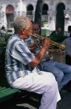 CUBA, Santiago de Cuba, Man playing trumpet in the Plaza Central.