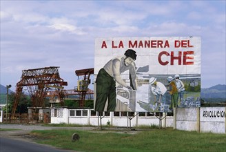 CUBA, Santiago de Cuba, "Billboard celebrating the work of Che Guevara, with industrial facilities