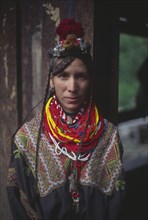 PAKISTAN, North West Frontier Province, Rumbur valley, Kalash woman wearing traditional dress.