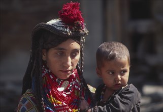 PAKISTAN, North West Frontier Province, Rumbur valley, "Mother wearing lots of colourful beaded