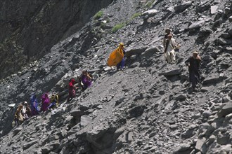 PAKISTAN, North West Frontier Province, Group of travellers negotiating a land slide on the