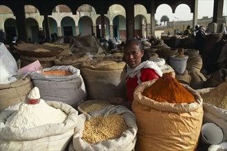 ERITREA, Asmara , "Woman selling spices, beans and lentils at market."
