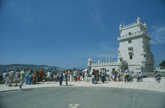 PORTUGAL, Lisbon, "Tower of Belem, tourists gathered round the fortress in the River Tagus."