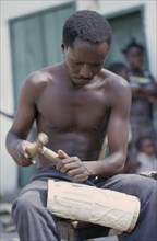 CONGO, Craft, Man carving piece of ivory.