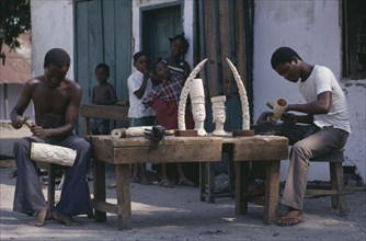 CONGO, Crafts, Men carving ivory with watching children.
