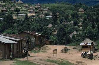 CONGO, East, Kavumba Village, Village huts scattered over hillside amongst trees and vegetation.
