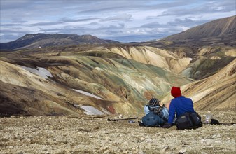 ICELAND, South Central, Colourful Rhyolite Mountains and trekkers admiring the view Landmannalaugar