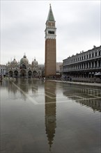 ITALY, Veneto, Venice, Aqua Alta High Water flooding in St Marks Square with St marks Basilica and