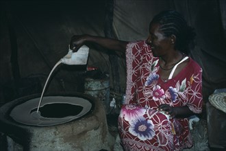 SUDAN, East, Food and Drink, Ethiopian refugee woman making Sudanese flat bread or Kisra.