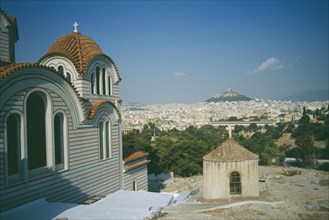 GREECE, Central, Athens, View of a church in the foreground and Acropolis and Lykavitos in the