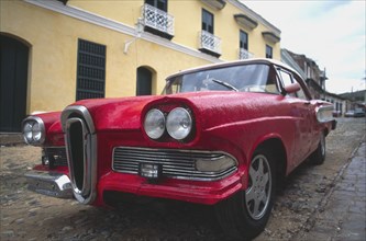 CUBA, Trinidad, A classic red US 1950s car.