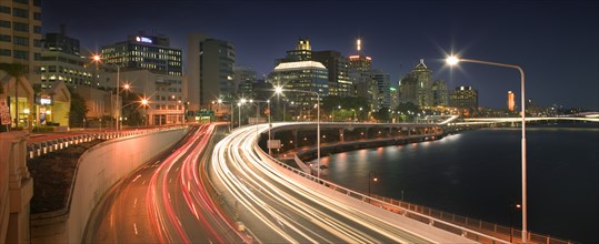 AUSTRALIA, Queensland, Brisbane, The Riverside Expressway snaking around the CBD. Car lights