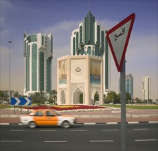 QATAR, Doha, "A car on the roundabout on The Corniche, with a road sign in the foreground."