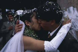BOLIVIA, La Paz, Wedding in El Monticulo. Bride and Groom kissing.