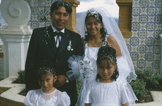 BOLIVIA, La Paz, "Wedding in El Monticulo. Bride, Groom and two young bridesmaids."