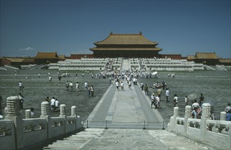 CHINA, Hebei, Beijing, Forbidden City. View from steps with tourists walking within the complex.