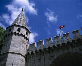 TURKEY, Istanbul, "Topkapi Palace. Entrance to grounds looking up at a tower, crenelated wall and