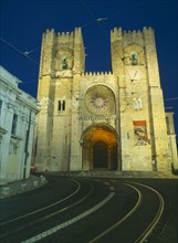 PORTUGAL, Lisbon, Alfama.  Se Cathedral exterior facade at night with two castellated bell towers