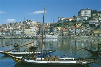 PORTUGAL, Porto, Oporto, The River Douro and waterside buildings with port barges or barcos rabelos