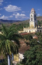 CUBA, Trinidad, Iglesia San Franciso de Paula roof and bell tower with red tiled rooftops and palm