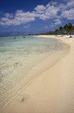 CUBA, Peninsula de Ancon, "Empty strip of sandy beach, clear shallow water and palms near Trinidad