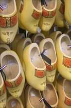 HOLLAND, Shoe Display, Clogs for sale with painted detail and hanging in rows.