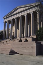 USA, Washington D.C., "Entrance to the National Gallery of Art, people sat on the steps."