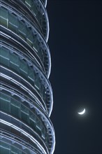 MALAYSIA, Peninsular, Kuala Lumpur, Detail of the Petronis Towers at night with a crescent moon