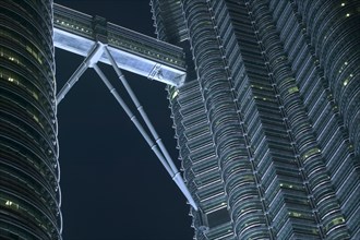 MALAYSIA, Peninsular, Kuala Lumpur,  Detail of the Petronis Towers at night showing walkway between
