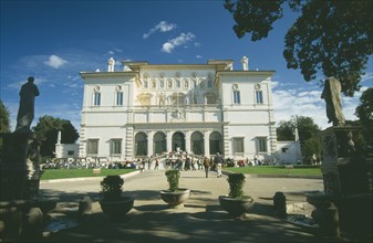 ITALY, Lazio, Rome, Vila Borghese.  Exterior facade and gardens with crowds of visitors.