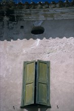 SPAIN, Balearic Islands, Menorca, Mahon.  Detail of house facade with green window shutter in Plaza