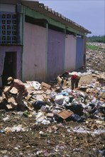 COLOMBIA, San Andres, "Two people searching through rubbish, waste collection site."
