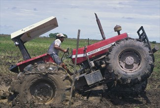COLOMBIA, Casanare, "Tractor stuck in a rice field, owned by Lasmo Oil."