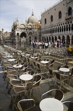 ITALY, Veneto, Venice, Aqua Alta High Water flooding in St Marks Square with restaurant tables in