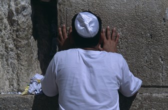ISRAEL, Jerusalem, A Jewish man wearing a white Kippah praying at the Western Wall