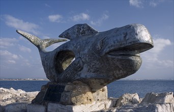 ISRAEL, Acre, A giant sculpture of a whale with the sea in the background
