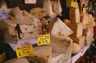 ITALY, Sicily, Catania, Market cheese stall with detail of a selection of cheeses and euro money