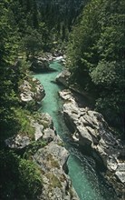SLOVENIA , Trenta Valley, "The clear green water of the Soca River flowing through a narrow gorge