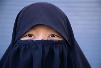 THAILAND, North, Pai, Head and shoulders portrait of Muslim girl wearing a Niqab