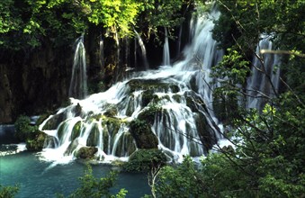 CROATIA, Lika, Plitvice, Plitvice lakes waterfall into lower lakes. Water follows the sinuous