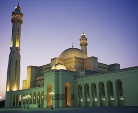 BAHRAIN, Manama, Al Faith Mosque.  Exterior and minaret illuminated at night.