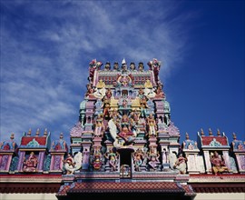 MALAYSIA, Penang, Georgetown, Sri Mariamman Temple.  Part view of exterior roof and gopuram painted